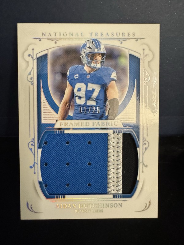 2025 National Treasures – Framed Fabric Aidan Hutchinson Holo Silver /25 Lions