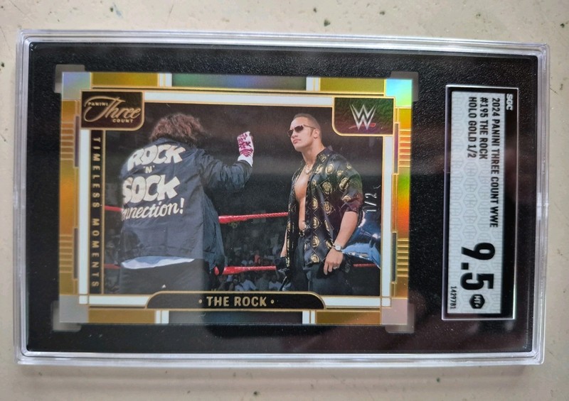 2024 Panini Three Count WWE The Rock ( GOLD HOLO 1/2 ) SSP SGC 9.5 Rock & Sock